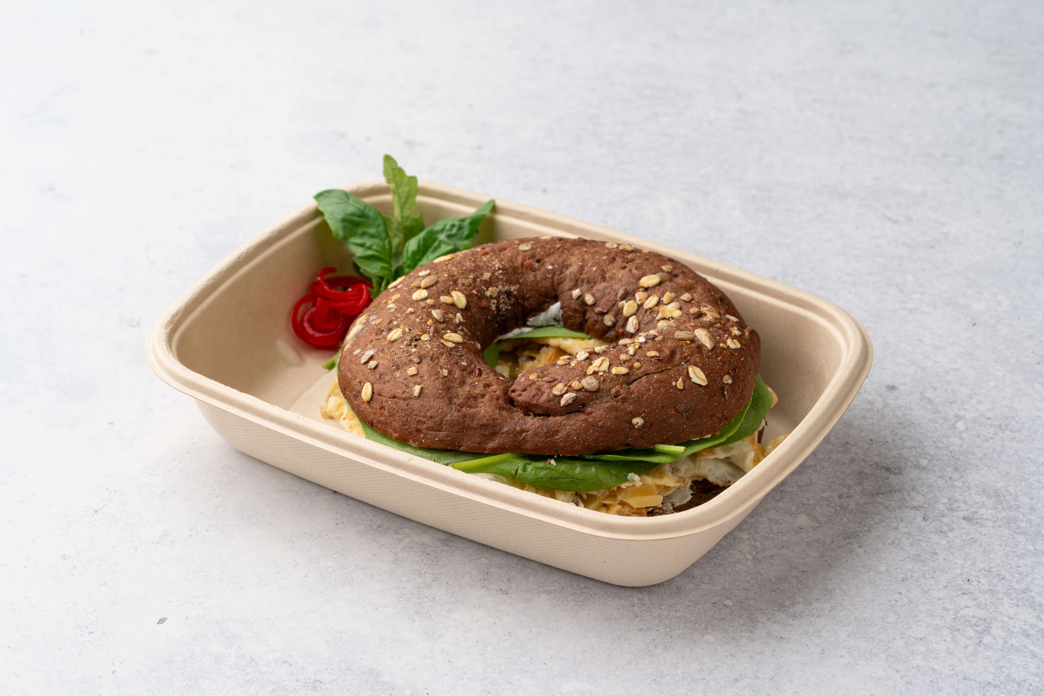 White Egg Bagel Sandwich With Cheese And Spinach